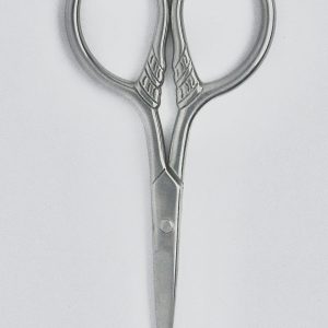 Photo by Nacho Lledรฒ Close-up of elegant vintage stainless steel scissors on a clean white background.